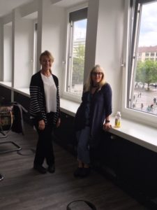 two women near a group of windows smiling