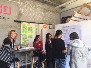 students writing on a large poster sized sheet of paper