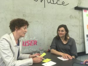 dr fortune and dr benesh at a table writing on yellow cards
