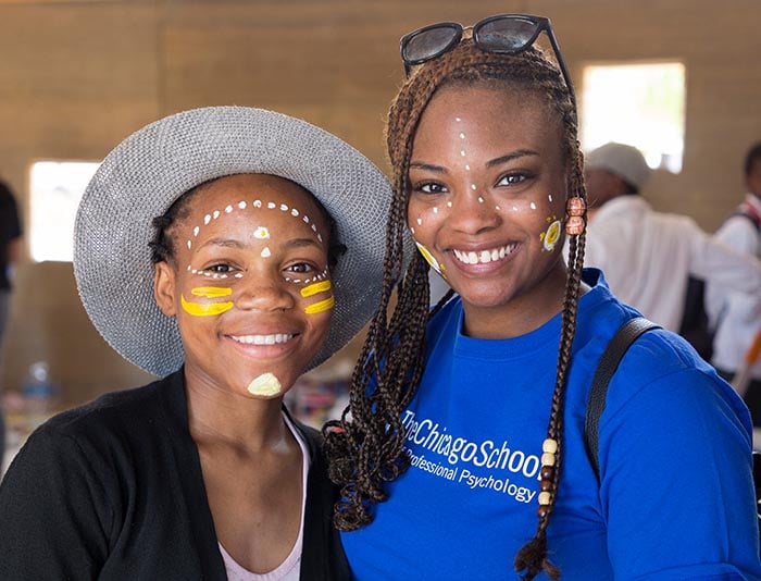 woman and girl with white painted dots on their faces smiling